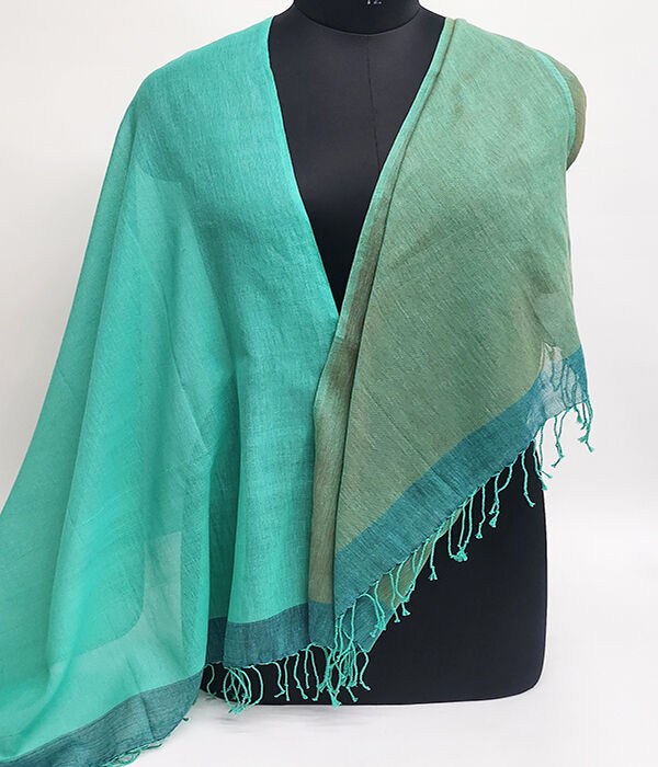 fine cotton turquoise and green scarf draped across a mannequin
