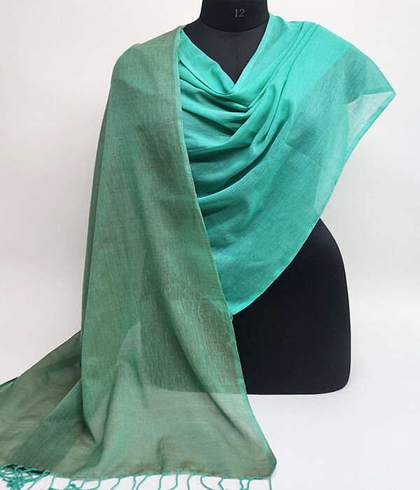 Fine hand woven cotton scarf draped on a mannequin.