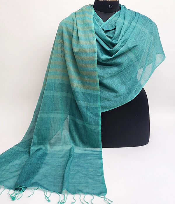 A gorgeous lightweight turquoise cotton scarf draped on a mannequin