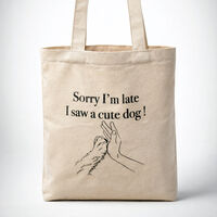 natural canvas tote bag with the print of a hand high fiving a dog's paw and the message " Sorry I'm late I saw a cute dog!"