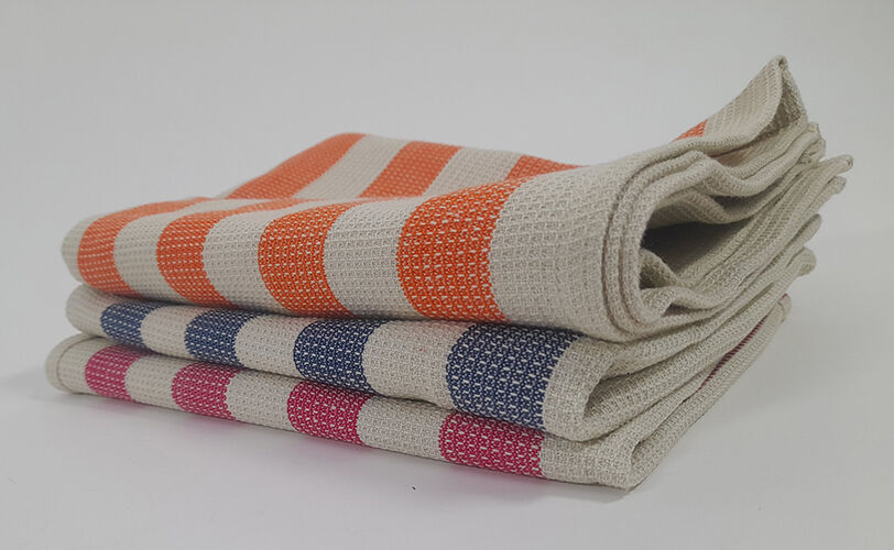 Three textured, striped tea towels folded and stacked