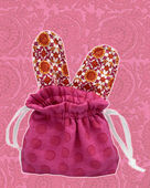 Bunny Ear Pouch Red draw string bag with patterned bunny ears.