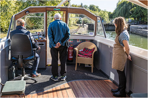 The helmsman having some assistance guiding the boat