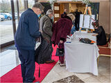 Arriving guests checking in and to find out at which table they were sitting