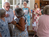 As people arrived, the "Welcome Girls!" greeted them and told them which table they were on