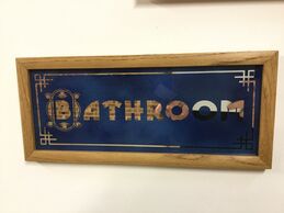 Bathroom sign, mirror with blue background