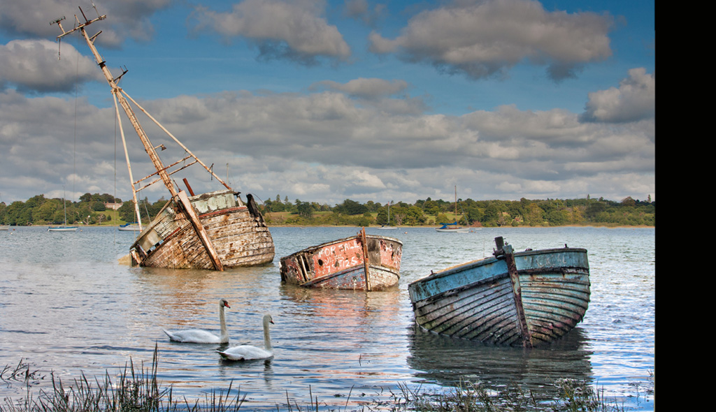 Old Wrecks and Swans Pin Mill Suffolk