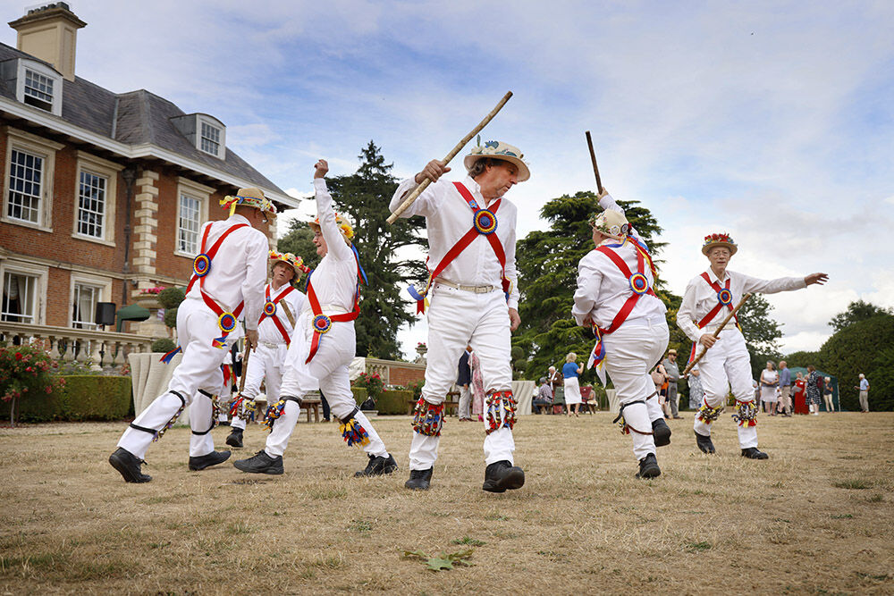 Morris dancers performing outside Highnam Court country house, Gloucester
