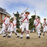 Morris dancers performing outside Highnam Court country house, Gloucester