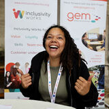 A smiling young woman at a jobs fair Gloucester event PR photography by Thousand Word Media Gloucestershire.