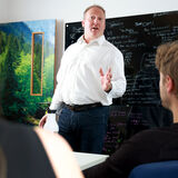 A managing director talking to staff in a meeting corporate portrait photography by Thousand Word Media Cheltenham
