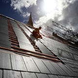 A roofer working on a church roof in sunshine in Newport Wales architectural photography by Thousand Word Media Gloucester