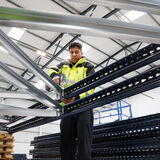 A worker in a warehouse installing BigDug shelving corporate photography by Thousand Word Media