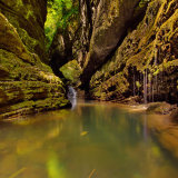 The limpid waters of the Pelago Torrent within the rock walls of the Orrido di Botri gorge