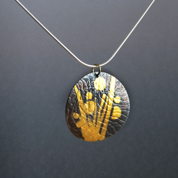 N19019 - Domed circular pendant with 24kt gold with oxidized, textured background