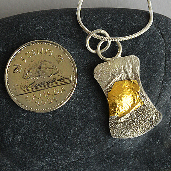 N180037 -Small hour-glass shaped pendant. 24kt gold on reticulated silver,