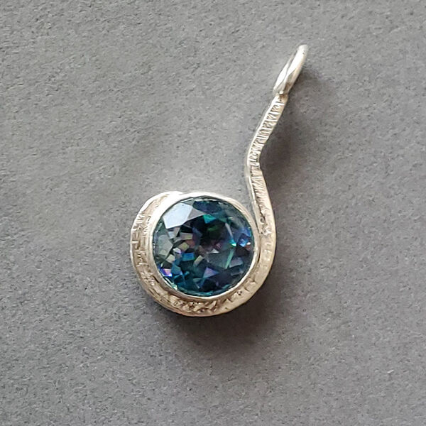 N20001 - faceted stone in forged silver cradle