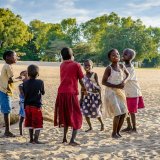 Children dancing on the shore of lake Malawi