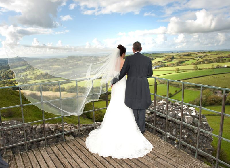 Bride and Groom enjoy the view at Carreg Cennen Castle, Llandeilo