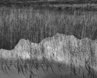 The dark reflections of the menacing Cuillin are juxtaposed by the sense of light and tranquility in the reflected sky