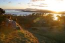 Couple enjoying the sunset & view at the Haylie Brae Largs looking towards Arran & Cumbrae
