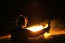 A viking stands watch over the burning longship