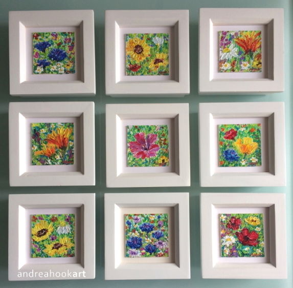 Nine miniature wildflower paintings - framed in white wood.