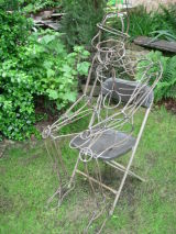'Man sat in chair' sculpture, made from steel rod