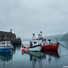 A Misty Start fishing boats in harbour on a calm misty morning