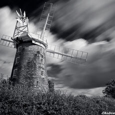 Fendick's Mill. Dereham clouds rushing by a large windmill on a summer afternoon
