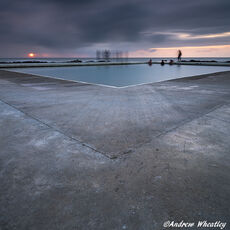 The Casual Observers People watching the sunset on the edge of a tidal sea pool