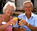 RETIRED COUPLE RELAXING WITH A DRINK