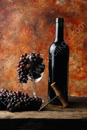 RED WINE BOTTLE WITH GRAPES IN A GLASS