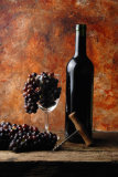 RED WINE BOTTLE WITH GRAPES IN A GLASS