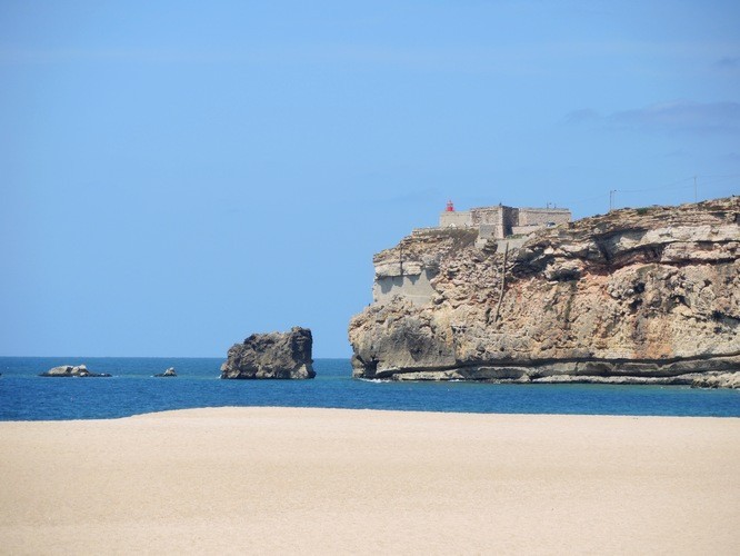White sand, high cliffs, blue skies