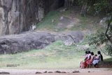 Buburuwagala. This was a beautiful, quiet place, there were huge carvings of Buddha in the rock, these people arrived and sat opposite the carvings, I thought it made a lovely picture