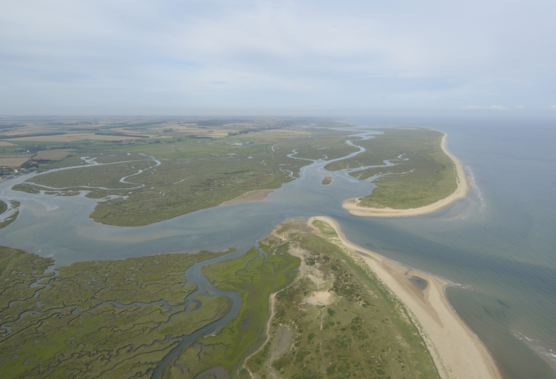 Aerial view of Scolt Head Island with Burnham Overy harbour and Gun Hill in the foreground.
