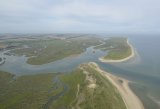 Aerial view of Scolt Head Island with Burnham Overy harbour and Gun Hill in the foreground.