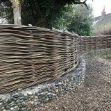 Burnham Willow Woven Willow Fencing North norfolk Burnham Willow Woven Fencing on Flint wall