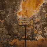 A street sign against a well weathered wall