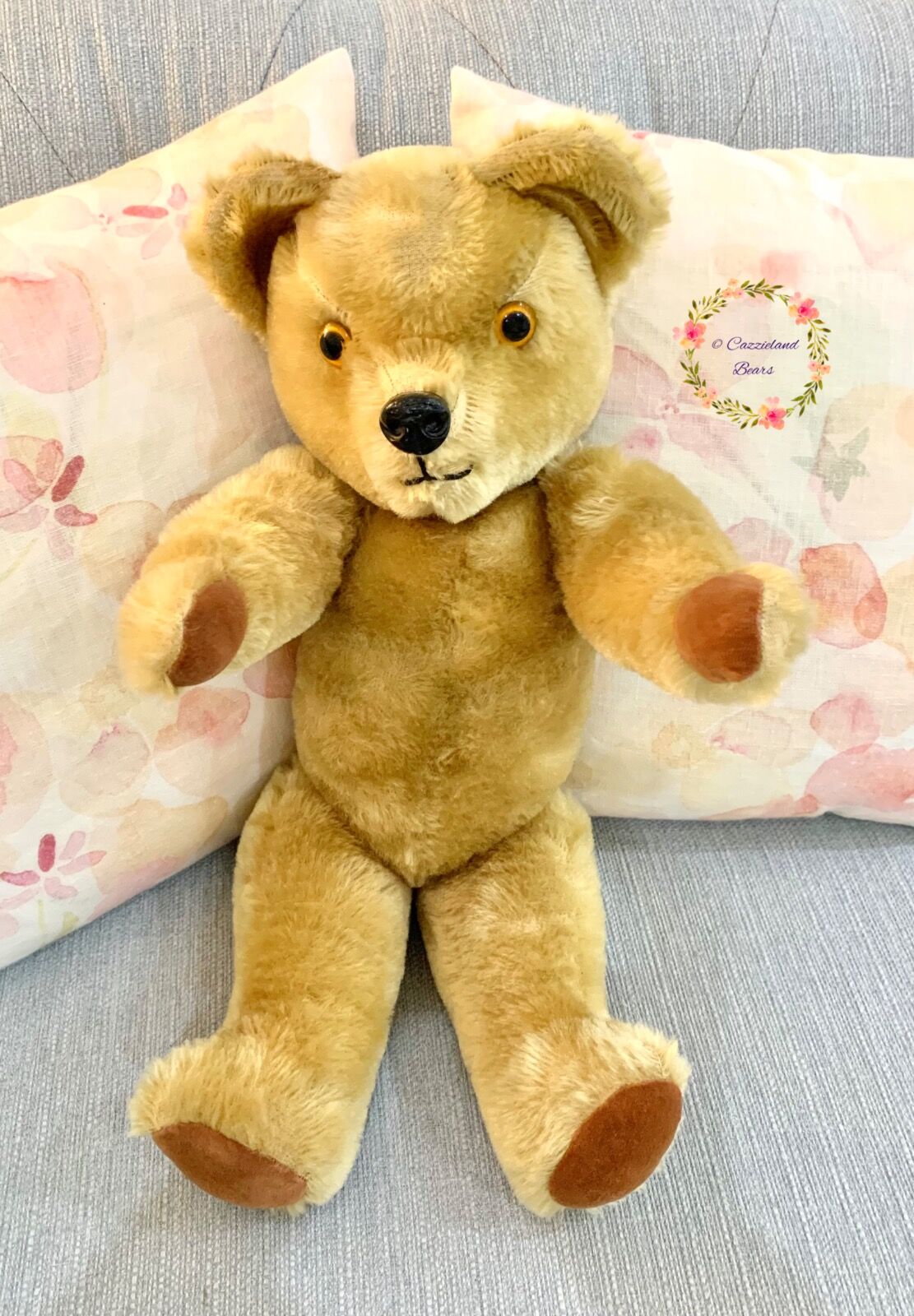 Growly bear's transformation after a good clean, new paw pads and careful stitching to repair a few holes.