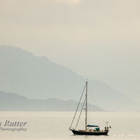 Yacht and misty shore