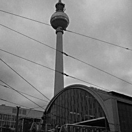 The TV tower looms over the railway station in Alexanderplatz on a dull morning.