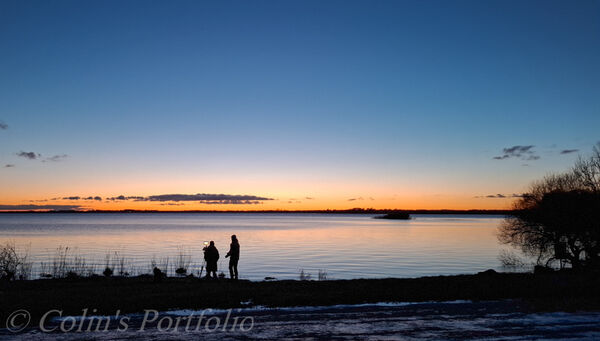 Two photographers capturing the winter sunset