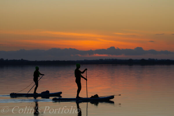 Padelboarders enjoying the still conditions at sunset.