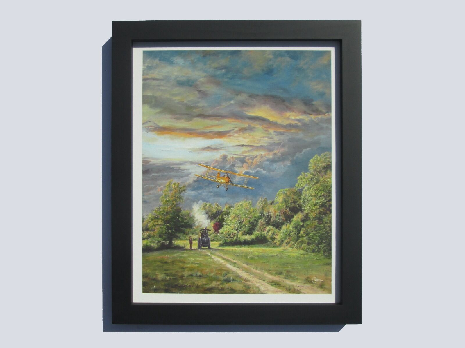 Painting of a Tiger Moth aircraft flying low over an Aveling and Porter Traction engine at sunset in a field with trees in background.