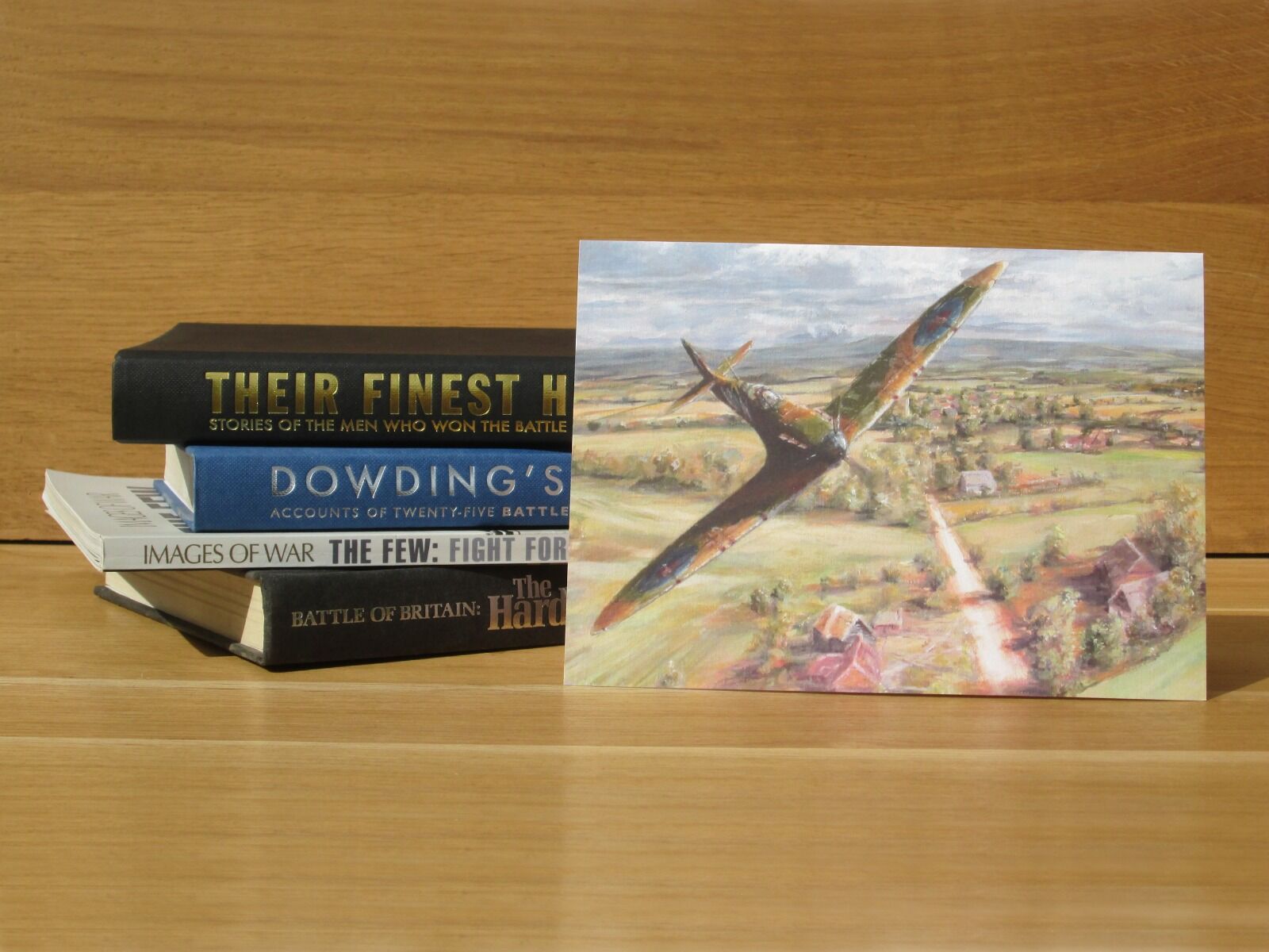 Painting of single Spitfire over golf course.