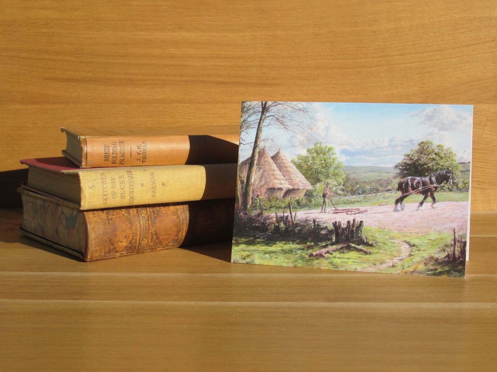 Painting of man and horse harrowing a field