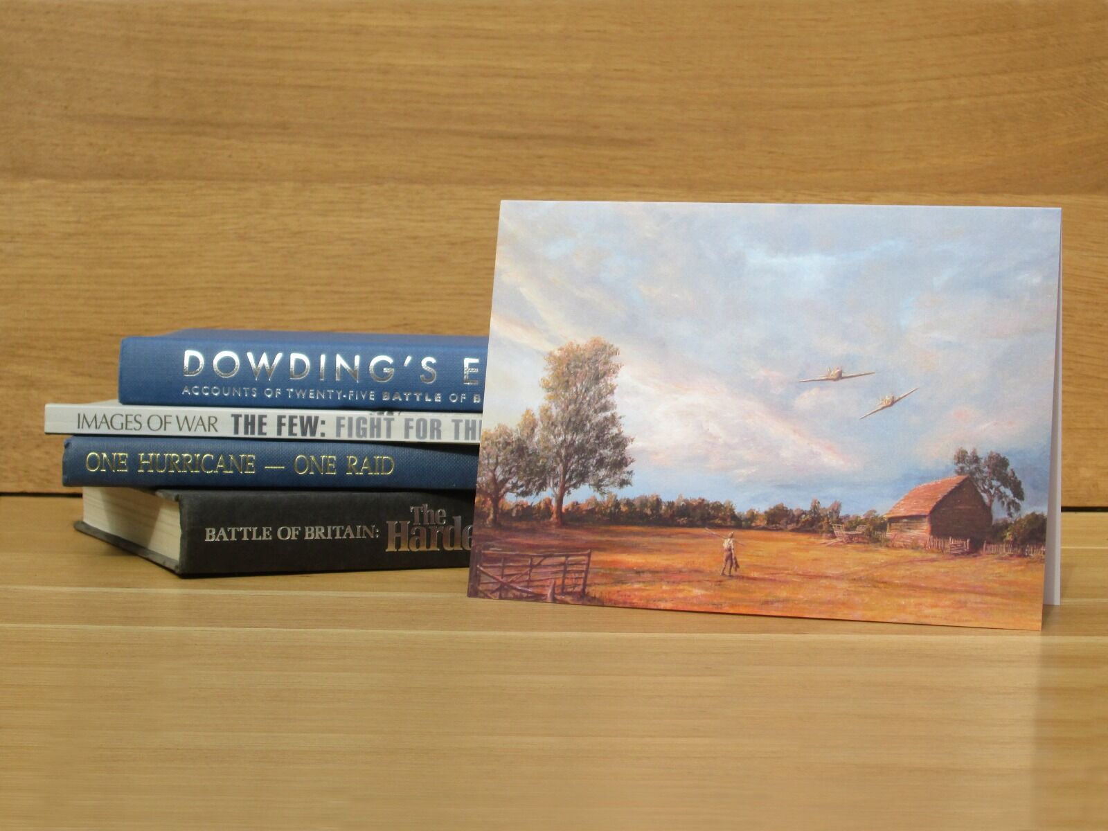 Hurricanes fly low over a farmworker, barn and trees at sunset