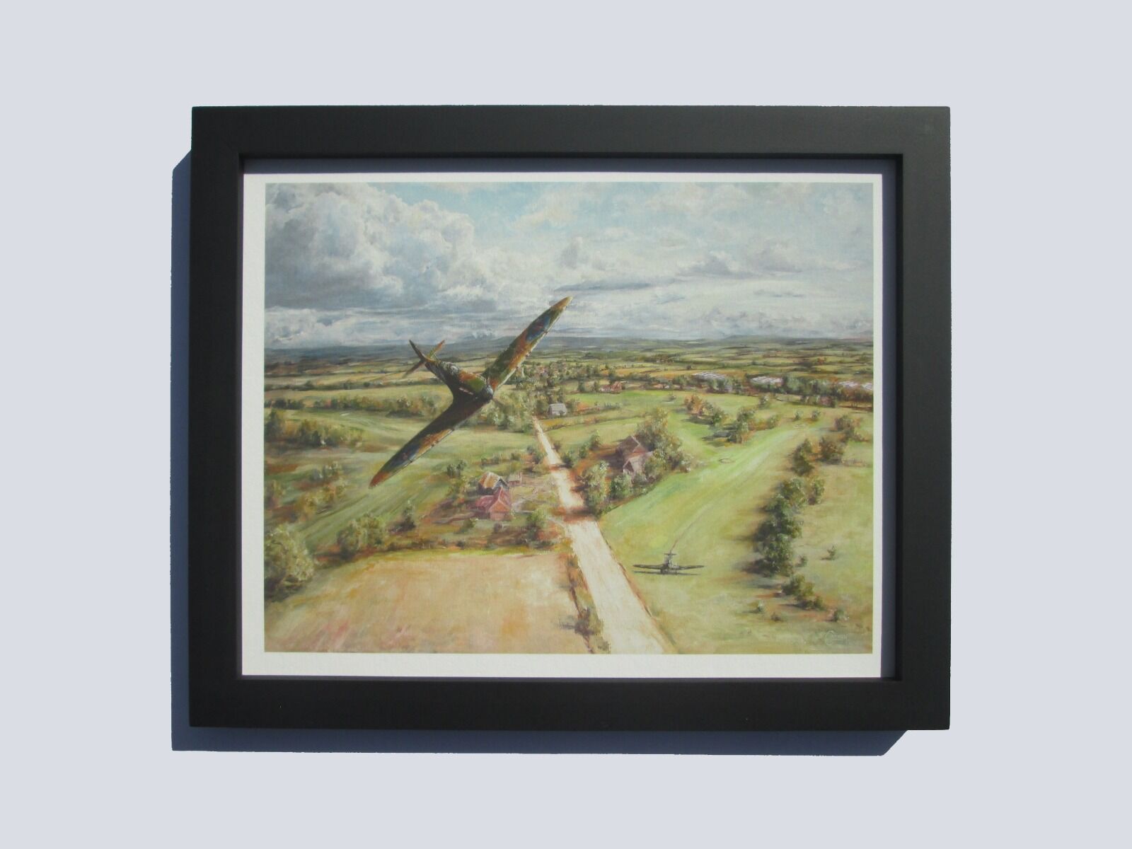 Painting of B. Whall's Spitfire flying over a golf course on which a Stuka Aircraft has landed.
